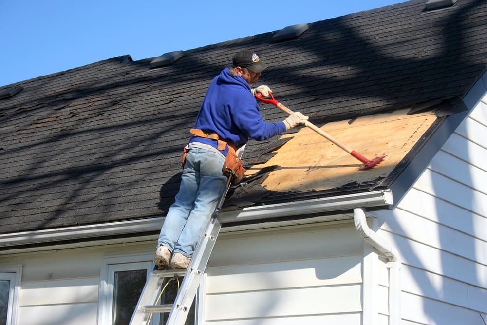 Roofing ladder set at the edge of a home